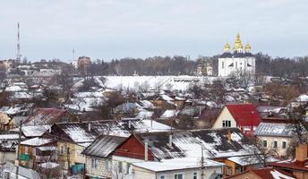 Orthodox Church of St. Catherine in the Ukrainian city of Chernihiv and a view of the city in winter with snow. Old beautiful temple in the city. photo