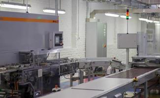 Line for the production of chocolate in an industrial factory. Automatic process in the production line of sweets. Images from the chocolate factory during production. Conveyor belt with sweets. photo