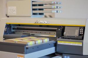 Printing machines in production. Mimaki logo on UV flatbed printer. Mimaki Engineering is a global industry manufacturer of large format inkjet printers. Ukraine, Kiev - February 09, 2022. photo