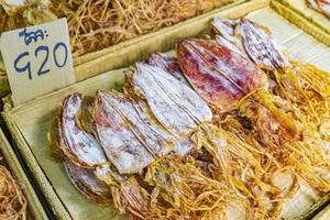 Buy dried squid Thai street food China Town Bangkok Thailand. photo