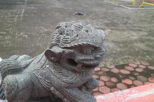 a stone statue of a little lion photo