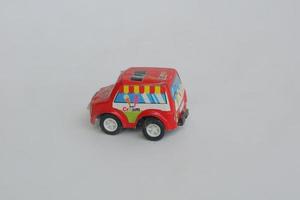 small red toy car on a white background photo