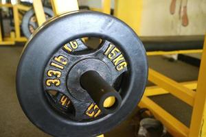 Editorial image of a 15 KG black barbell plate for exercising in the gym photo