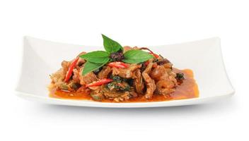 Stir Fried Wild Boar with Red Curry isolated on white background with clipping path, thai food style, Spicy thai food stir fried with Thai herb. photo