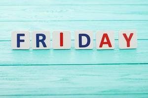 word friday letters on blue wooden background. Black friday sales. Top view. Copy space. Mock up. Selective focus photo