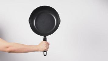 Hand cleaning the non stick pan with handy dish washing sponge photo