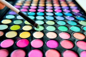 Palette of colorful eye shadows and make up brush photo