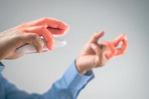 The man uses a mouse until his fingers pain. Office syndrome concept. Pain symptom area is shown with red color. Medium close up shot with some copy space. photo