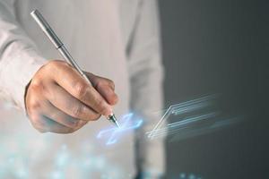 Health insurance concept. The man prepares a pen to sign online agreement. This shot was focus on the hand. photo