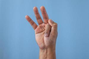 Office syndrome concept. Index finger is stretched after working. Close up shot isolates on blue background. photo