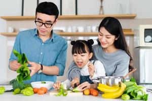 image of an asian family cooking at home photo