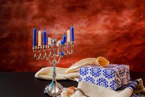 jewish holiday Hanukkah with menorah over wooden table photo