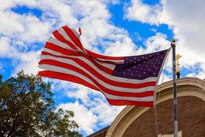 American flag and religious cross at sunset photo