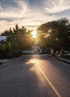 Rural asphalt road at sunset photo