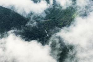 Scenery of Tram Ton Pass or O Quy Ho Pass is mountain pass winding in valley with foggy at Sapa, Northwest Vietnam photo