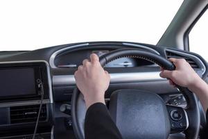 Hand holding steering wheel in modern private car with blank windshield photo