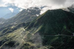 Scenery of Tram Ton Pass or O Quy Ho Pass is mountain pass winding in valley with foggy at Sapa, Northwest Vietnam photo
