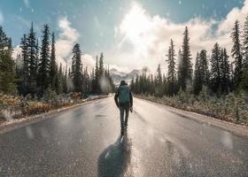 Man backpacker walking with snowing in Banff national park photo