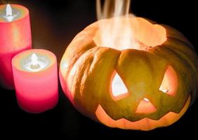 Glowing halloween pumpkin in candlelight photo