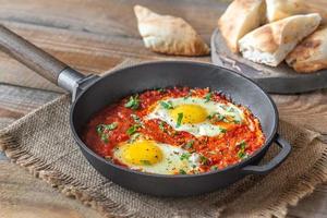 Shakshouka served in a frying pan photo