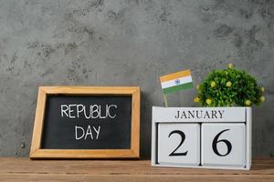 Republic Day written in it and a flag of India, on a rustic wooden surface photo