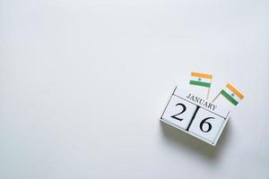 Wooden calendar of January 26th with miniature India flags. photo