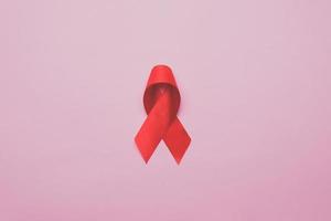 Hands holding red ribbon, hiv awareness concept photo