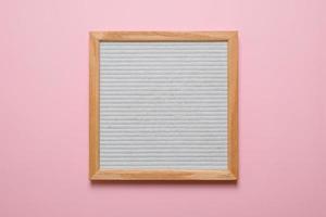 Blank white letter board isolated on pink background photo