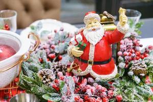 Colorful christmas souvenirs, decorative figurines of santa claus, dishes photo