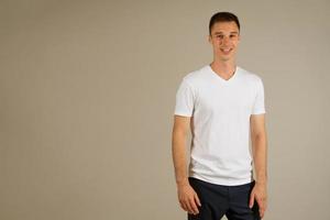 young adult man posing emotionally on a white background photo