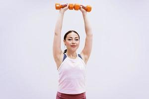 Happy woman doing fitness with dumbbells photo