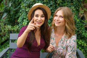 two cheerful friends laughing in the street on a green background photo