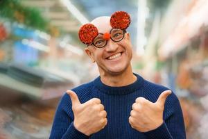 Funny bald man in carnival glasses photo