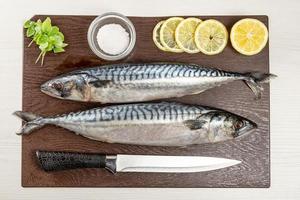Raw mackerel on brown cutting board