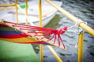 The backyard rope hammock held by metal railing photo