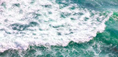 scenic aerial shot of blue ocean with foamy waves for background photo