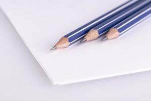 the three pencil on white paper photo