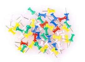 Colored pushpins on white background photo