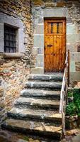 The ancient wooden door and stone staircase photo