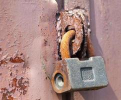 The padlock on the door. Rusty gate photo