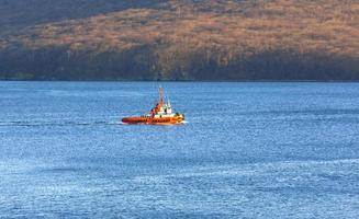 Thre View of a small tugboat in the sea photo