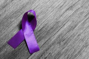 Purple ribbon as symbol of World Cancer Day concept photo