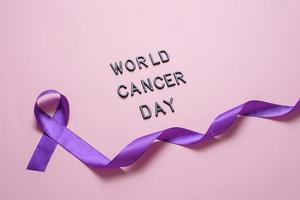 Purple ribbon as symbol of World Cancer Day concept photo