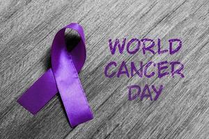 Purple ribbon as symbol of World Cancer Day concept photo