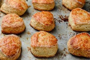 cheese buns scones on a mettalic baking sheet. photo