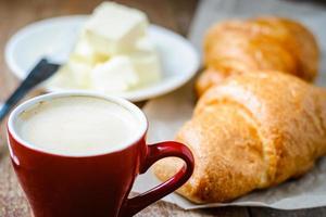 breakfast with cup of coffee and croissants with butter photo