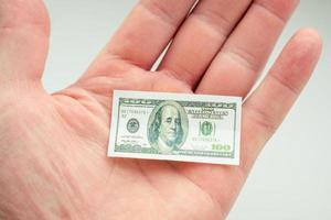 hand holding small banknote of US dollar photo