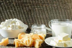 different kinds of fresh dairy products on a wooden table