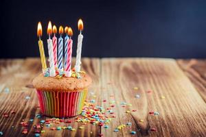 Cupcake decorated with lighted festive candles photo