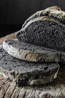 Black bread on wooden table photo